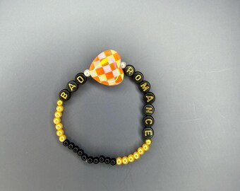 Bracciale Bad Romance arancione e nero di Lady Gaga
