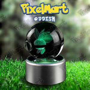 May include: A black and clear glass sphere with a green Oddish design, resting on a silver base. The sphere is illuminated with green light, and the PixelMart logo is visible above. The background is blurred green.