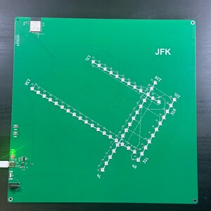 May include: A green circuit board with the letters "JFK" printed on it. The board features a detailed layout of an airport runway system, with numerous small white lights indicating runway paths and markings. Various electronic components are visible.