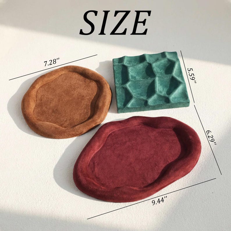 May include: Three decorative trays in shades of brown, teal, and burgundy. The brown tray is 7.28 inches in diameter, the teal tray is 5.59 inches by 5.59 inches, and the burgundy tray is 9.44 inches by 6.29 inches. The word "SIZE" is at the top.