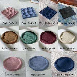 May include: A grid of cushions in various colors, including pink, blue, sapphire, and black, with textured surfaces. The cushions are labeled with color names and style designations.