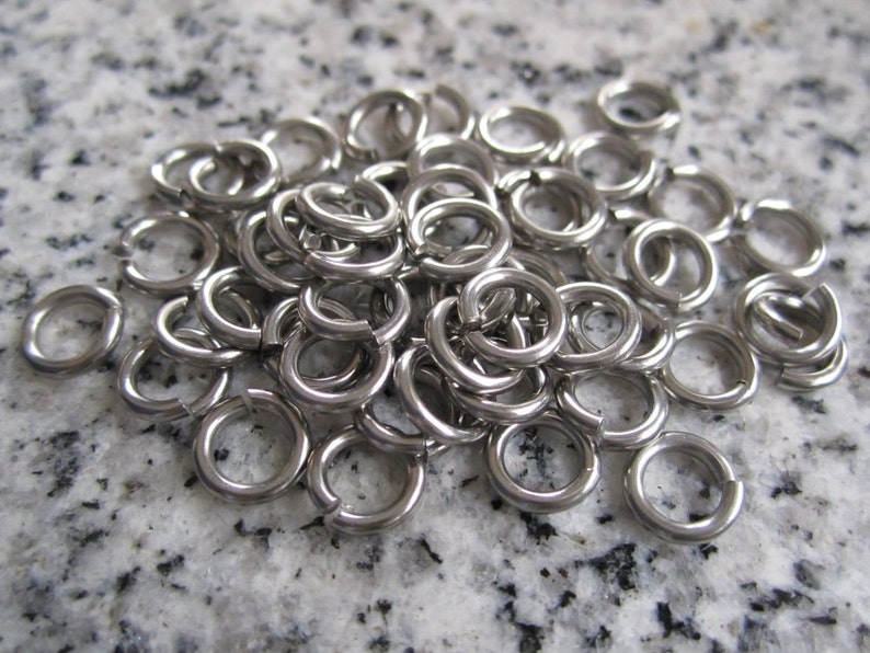 100 Qty. 7mm OD, 4.6mm ID, 18g 1.2mm Saw Cut Stainless Steel Jump Rings JR18-07 image 1