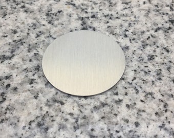 May include: A round, brushed silver metal cover plate.