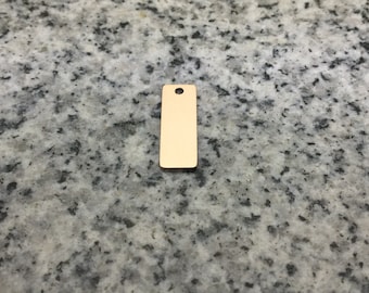 May include: A gold-colored metal tag with a hole at the top. The tag is rectangular and has a smooth surface.