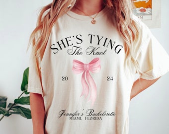 She's Tying the Knot Bachelorette Shirts, Custom Bachelorette Tees, Personalized Coquette Bow Bachelorette, Custom Location Bach Shirts