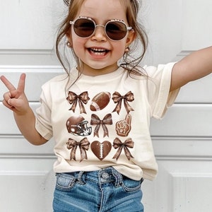 Kids Football Shirt with Coquette Bows, Cute Girls Football Tee, Football Season Top, Toddler Football T-Shirt, Youth Football Shirt