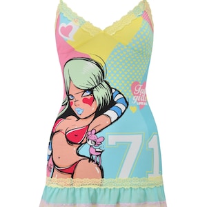 May include: A colorful camisole dress with spaghetti straps. The dress features a cartoon graphic of a woman in a bikini, with the number 71. The dress has a ruffled hem and lace trim in yellow, pink, and blue.