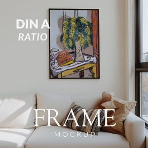 May include: A framed artwork featuring a still life with a vase of yellow flowers, a book, and a wine glass. The artwork is displayed above a white sofa with decorative pillows. The text "DIN A RATIO" and "FRAME MOCKUP" are overlaid on the image.