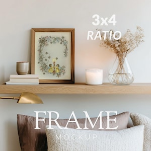 May include: A framed print with a vintage illustration of two children holding candles, surrounded by floral and star accents. The frame is a warm brown color. The image is displayed on a wooden shelf with a candle, vase, and books. The text "3x4 RATIO" is visible.
