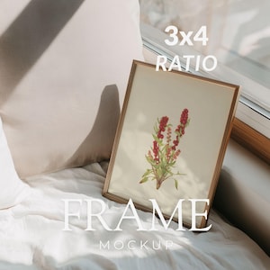 May include: A gold-coloured framed print featuring a botanical illustration of red berries and green leaves. The frame rests against a window on a white surface. Text on the image reads "3x4 RATIO FRAME MOCKUP."