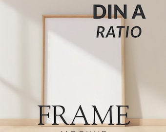 May include: A wooden framed art print mockup with the text "DIN A RATIO" and "FRAME MOCKUP" in black. The frame is leaning against a light-colored wall and floor, with a shadow cast across the surface.