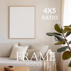 May include: A framed mockup with a 4x5 ratio, displayed above a beige sofa with decorative pillows. The frame has a light wood finish. The word "FRAME" and "MOCKUP" are displayed in white text. A plant with large green leaves is on the right.