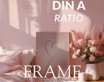 May include: A framed artwork with a heart sketch, set against a pink backdrop. The image includes a bed with pink linens, a vase of pink flowers, and the text "DIN A RATIO FRAME MOCKUP".