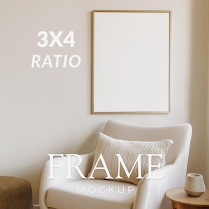 May include: A framed art mockup with a gold frame, displayed above a cream-colored armchair. The text "3X4 RATIO" and "FRAME MOCKUP" are visible. A decorative pillow and small wooden side table with a vase are also in the image.