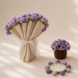 May include: A collection of crocheted items featuring a bouquet of purple flowers wrapped in beige fabric with a white ribbon, a small potted plant with purple flowers, a circular floral coaster, and a beige blanket with purple flower trim.