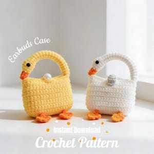 May include: Two crochet goose-shaped earbud cases, one yellow and one white, with orange beaks and feet. The cases have a handle and a pearl clasp. The text "Earbuds Case" and "Crochet Pattern" are visible.