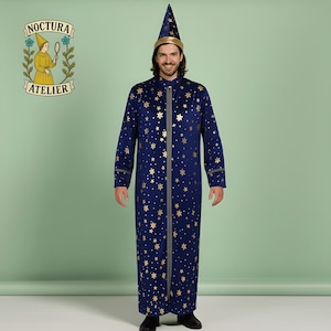 May include: A navy blue wizard costume with gold star patterns, a matching hat, and a gray zipper. The costume is part of the Noctura Atelier collection. The hat has a gold band. The costume is long-sleeved.
