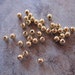 Bead Ends - Lot of 25, gold-plated brass, 3mm half-drilled round, for use with memory wire JD189
