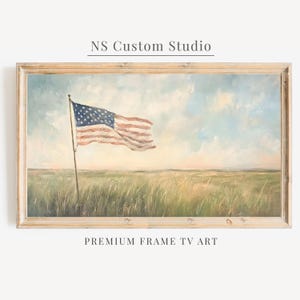 May include: A framed landscape painting featuring an American flag waving on a pole in a grassy field under a cloudy sky. The text NS Custom Studio appears above the frame, and the text PREMIUM FRAME TV ART appears below the frame.