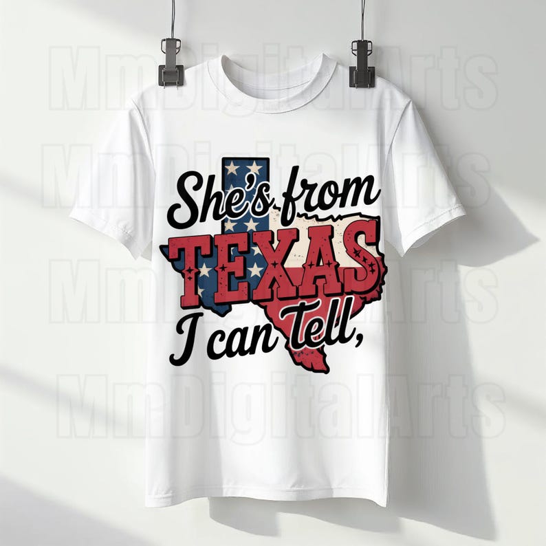 May include: White t-shirt with the phrase "She's from TEXAS I can tell," and a Texas-shaped graphic in red, white, and blue. A patriotic design, ideal for those with Texan pride.