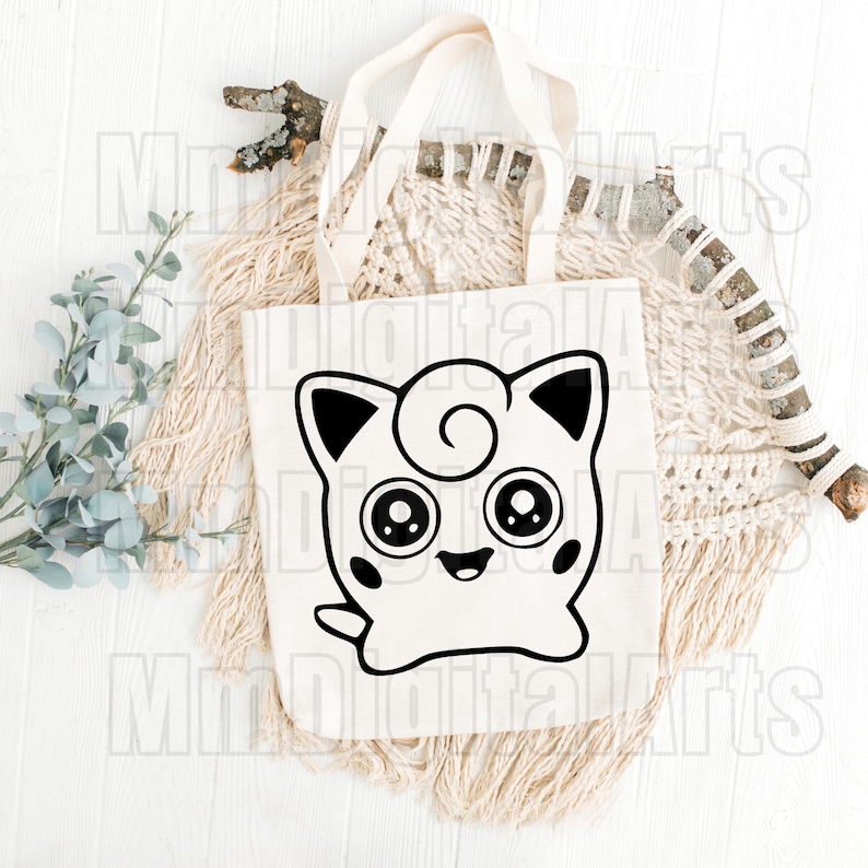May include: A white tote bag featuring a black and white cartoon character design. The character has large eyes, a smiling mouth, and a swirl on its head. The bag has a simple design with a rectangular shape and two handles.