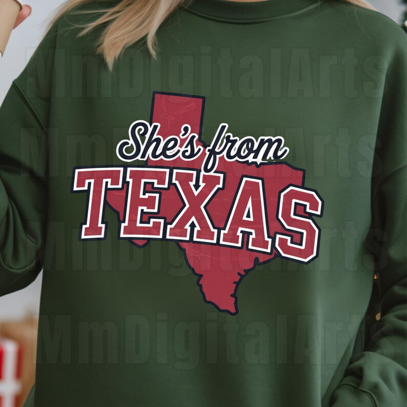May include: Dark green sweatshirt featuring the text "She's from TEXAS" in white and red, with a red outline of Texas. The sweatshirt is a plain, solid green colour.