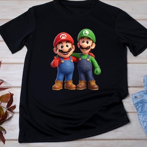May include: Black t-shirt featuring a colorful graphic of Mario and Luigi, characters from the Super Mario video game series. Mario is wearing a red hat and Luigi is wearing a green hat. Both characters are smiling and wearing overalls.
