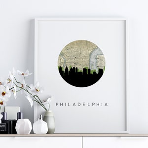 Philadelphia Pennsylvania city wall art featuring the Philadelphia skyline and a Philadelphia city map. Available in several cities and frame options. Philadelphia Pennsylvania shown in a white frame. Designed by www.etsy.com/shop/paperfinchdesign