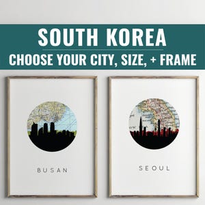 May include: Two framed art prints featuring South Korea city skylines. Each print has a circular map design with a black silhouette of a city skyline. The text "South Korea" and "Choose Your City, Size, + Frame" are at the top.