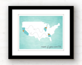 May include: Framed art print featuring a map of the United States with highlighted states and dotted lines. The states are colored in blue, with orange heart-shaped markers. The text "roam if you want to" is at the bottom.