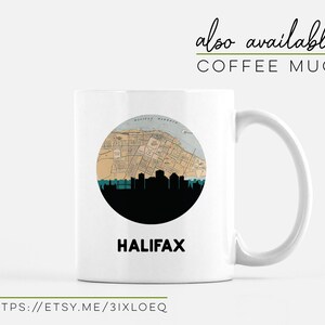 A white coffee mug features a circular Halifax map and skyline graphic with the city name underneath.