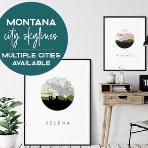 May include: Framed art prints featuring Montana city skylines. The prints showcase city silhouettes within a circular design, with the city name displayed below. The image includes a desk with a laptop and a potted plant.