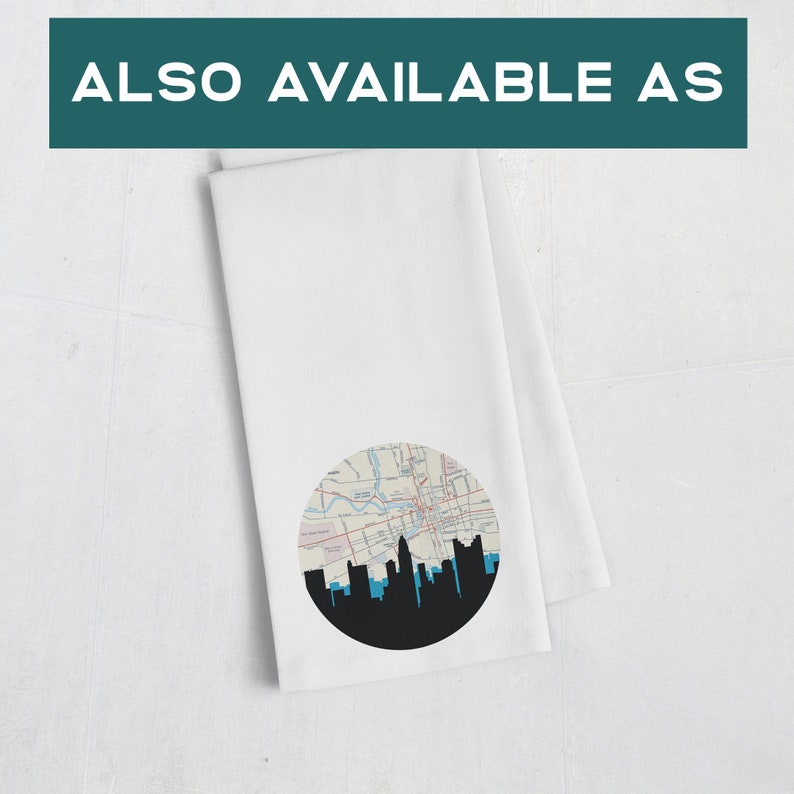 May include: White kitchen towel with a circular design featuring a city map and a black skyline silhouette. The text "ALSO AVAILABLE AS" is at the top of the image.