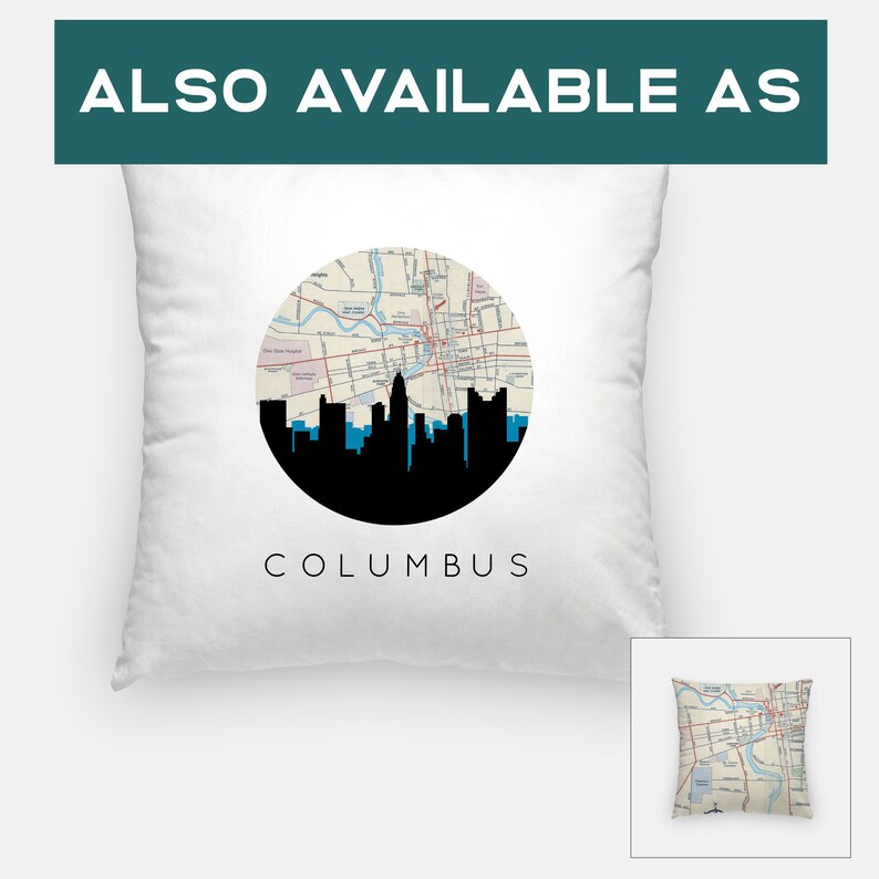 May include: White square pillow featuring a black silhouette of a city skyline, with the city name "COLUMBUS" printed below. A circular map design is centered above the skyline. The text "ALSO AVAILABLE AS" is at the top.