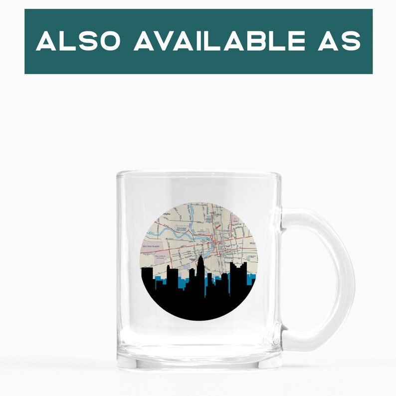 May include: Clear glass mug featuring a black and blue skyline silhouette against a circular map design. The mug has a handle and the text "ALSO AVAILABLE AS" is at the top.