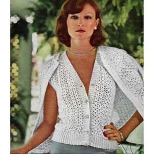 May include: A white crocheted cardigan with a V-neck and short sleeves. The cardigan has a button closure and a delicate openwork pattern.