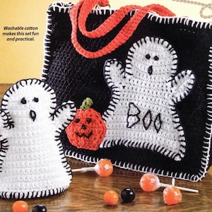 May include: A black and white crocheted tote bag with a white ghost applique that says "BOO". There is a smaller white ghost applique and a crocheted orange pumpkin applique on the bag. The bag is surrounded by candy and lollipops.