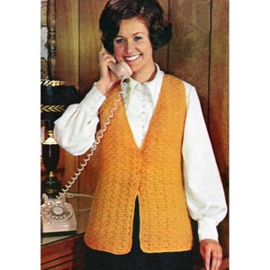 May include: A crocheted vest with a V-neck and button closure. The vest is a bright orange color and is made with a lacy stitch.