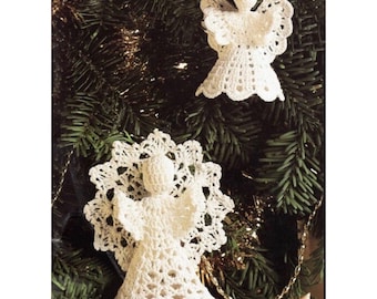 May include: Two white crocheted angel ornaments hanging on a green Christmas tree. The angels have delicate lace details and are a traditional festive decoration.