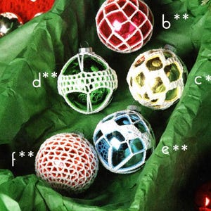 May include: Six crocheted Christmas ornaments in various colors, including red, white, blue, and green. The ornaments are displayed on a green background.