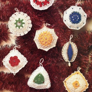 May include: A collection of handmade crochet Christmas ornaments in various shapes and colors. The ornaments include red, green, blue, and yellow accents, with intricate details and hanging loops. The ornaments are displayed on a red tinsel background.