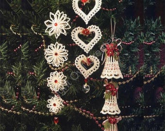 May include: A Christmas tree decorated with crocheted ornaments. The ornaments are in the shape of hearts, snowflakes, and bells. The ornaments are white with red accents.