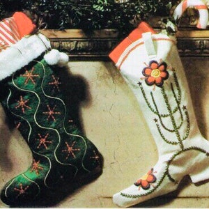 May include: Two Christmas stockings. One is green with a white cuff, snowflakes, and a white wavy design. The other is white with a red cuff and a floral and cactus design. One stocking is filled with a wrapped gift.