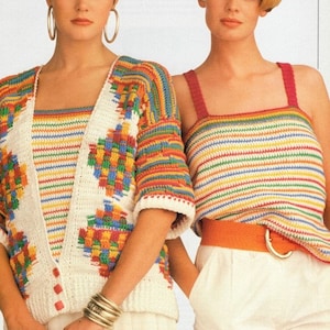 May include: Two women wearing colorful, crocheted tops. One has a white cardigan with a geometric design, the other a striped tank top. Both are paired with white shorts. The outfits feature rainbow colors.