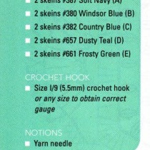 May include: A close-up of a teal yarn ball with the text "Super Saver in Dusty Teal" and the number "4" printed on a white label. The yarn is part of a crochet kit that includes instructions for making a blanket.