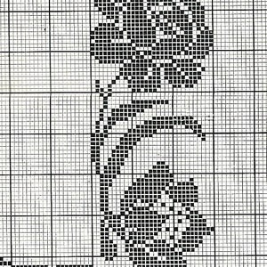 May include: Black and white cross stitch pattern featuring a floral design with leaves and flowers.