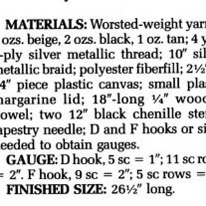 May include: Materials list for a craft project, including worsted-weight yarn in beige, black, and tan, silver metallic thread and braid, polyester fiberfill, plastic canvas, a margarine lid, a wooden dowel, chenille stems, tapestry needle, and crochet hooks.