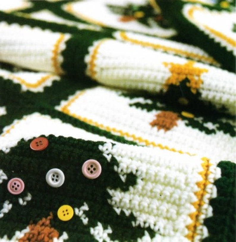 May include: A green and white crocheted blanket with a repeating pattern of squares and buttons. The blanket is made with a soft, textured yarn and has a vintage look.