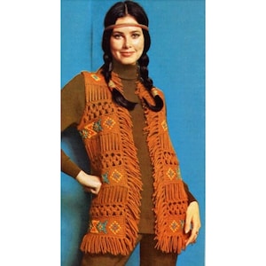 May include: A crocheted vest with a geometric pattern in shades of orange, yellow, blue, and green. The vest has fringe along the edges and is worn over a brown turtleneck.