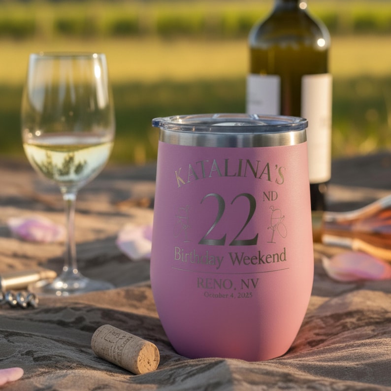 May include: A pink insulated wine tumbler with a silver rim and lid. The tumbler is engraved with "KATALINA'S 22nd Birthday Weekend, Reno, NV, October 4, 2025." A wine glass and bottle are in the background.